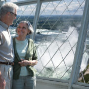two people overlooking niagara falls from skylon tower