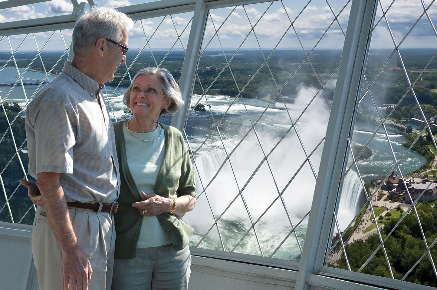 two people overlooking niagara falls from skylon tower